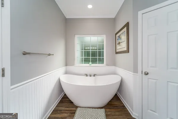 a bathroom with a granite countertop sink a mirror and a shower
