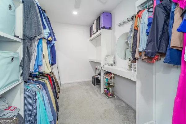 a living room with furniture a baby crib and a wooden floors