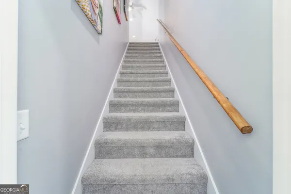 a view of a hallway with wooden shelves and cabinets
