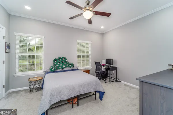 a bathroom with a granite countertop toilet a sink and a mirror