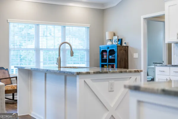 a bath room with a sink and a large mirror