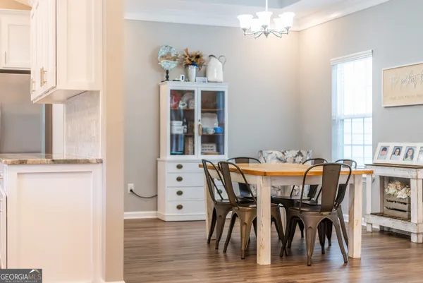 a view of a dining room with furniture window and wooden floor