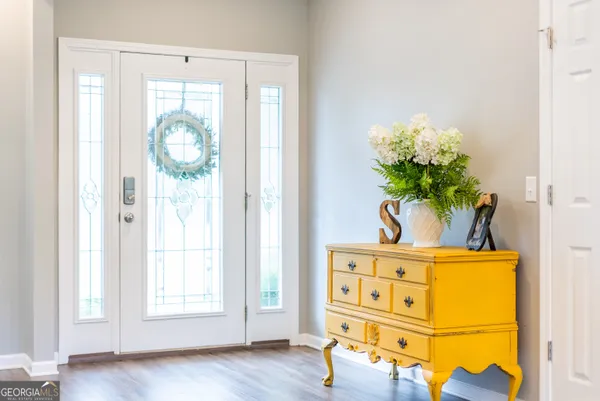 a view of hallway with wooden floor