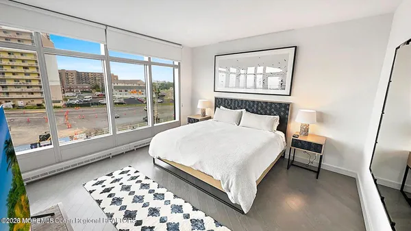 a bedroom with a large bed and a window