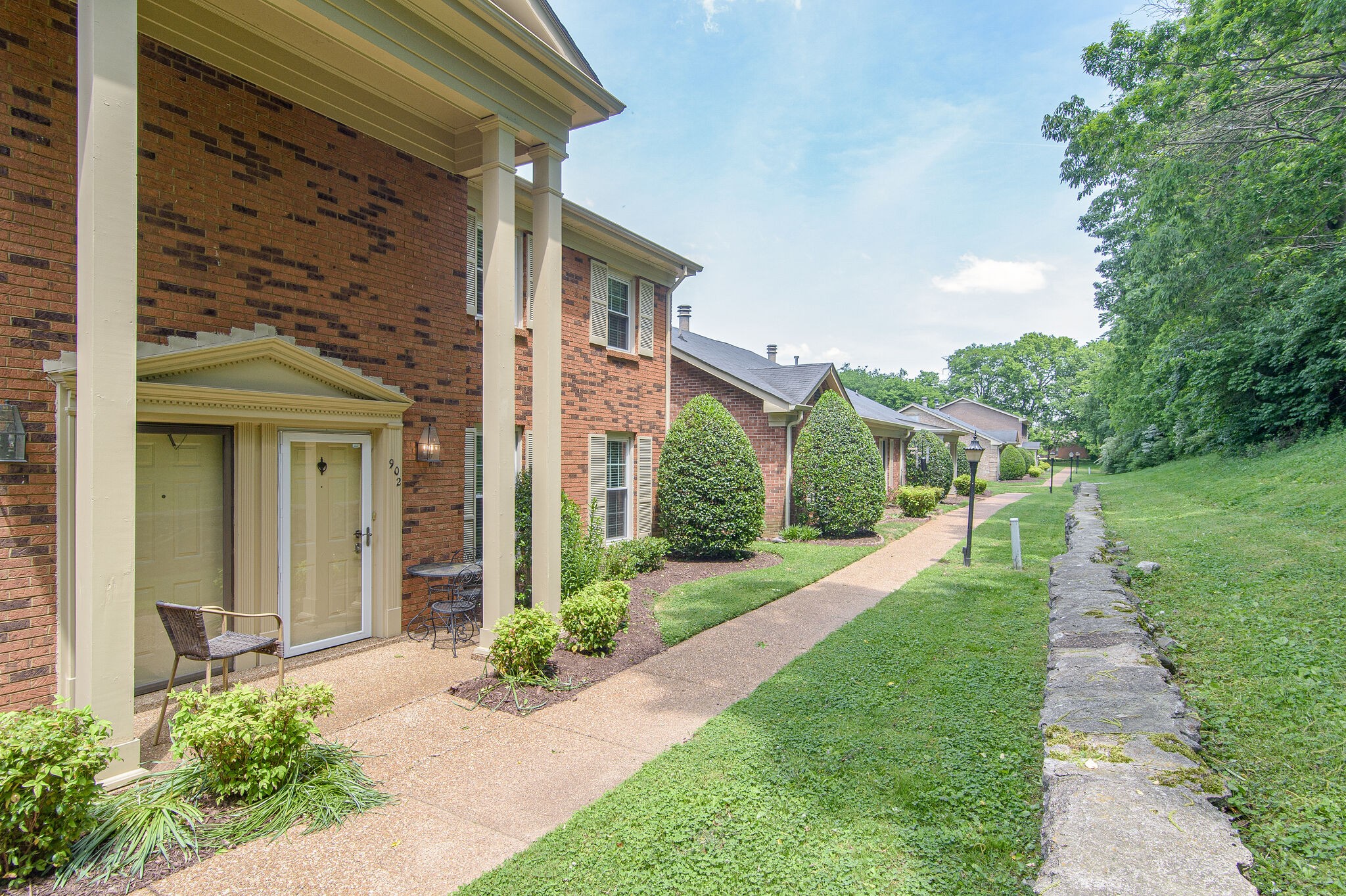 902 General George Patton Road Nashville, TN 37221 - Photo 2 of 22 a front view of a house with a yard and potted plants