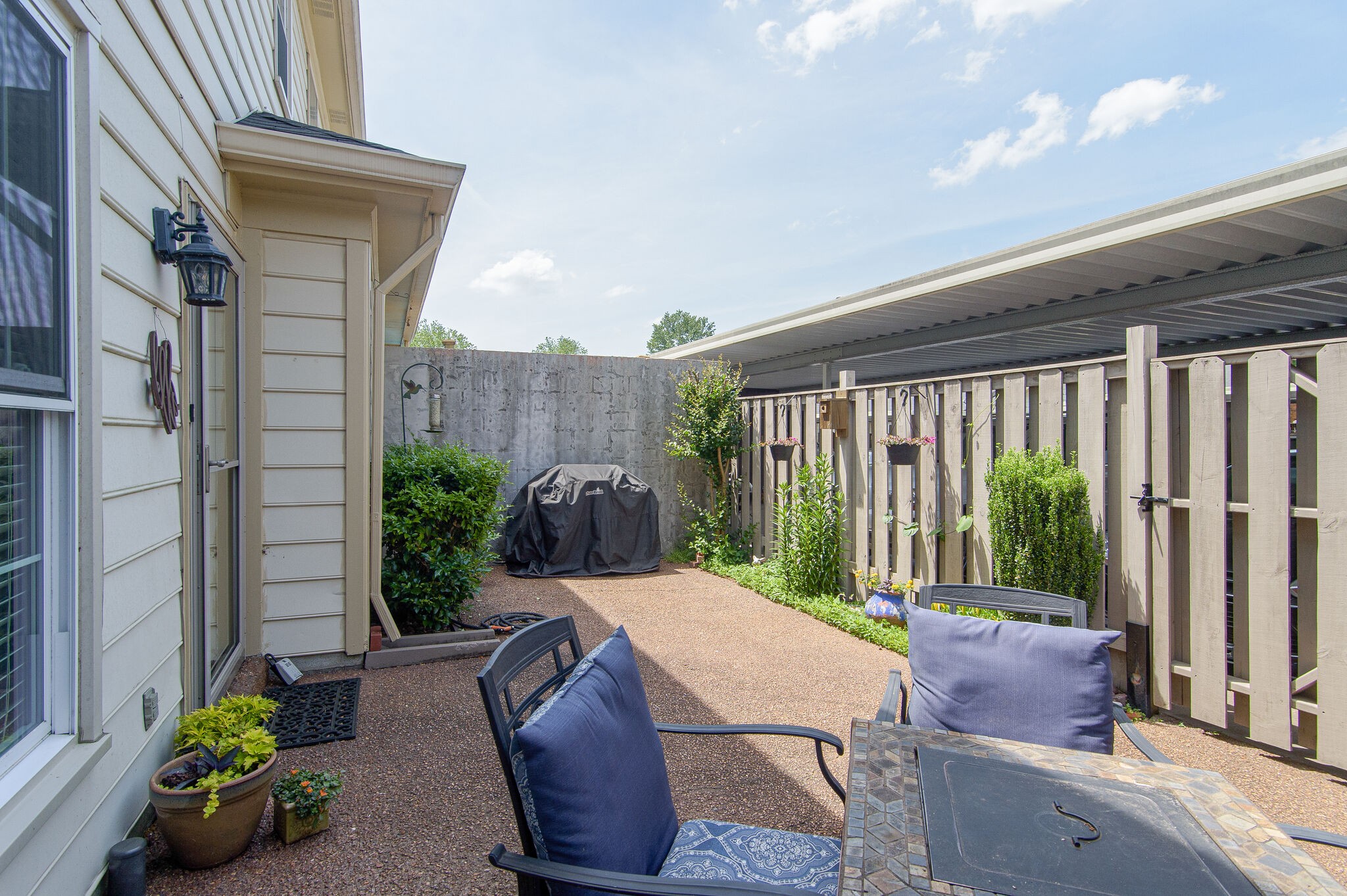 902 General George Patton Road Nashville, TN 37221 - Photo 21 of 22 a view of a patio with table and chairs potted plants with wooden floor and fence