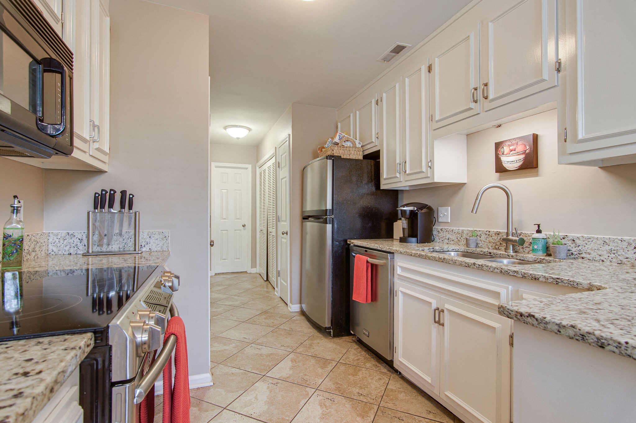 902 General George Patton Road Nashville, TN 37221 - Photo 10 of 22 a kitchen with stainless steel appliances granite countertop a sink refrigerator and cabinets