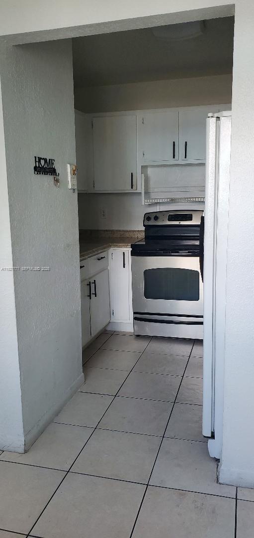 5702 West 26th Avenue, Unit 5702 Hialeah, FL 33016 - Photo 2 of 10 a kitchen with a stove and a refrigerator