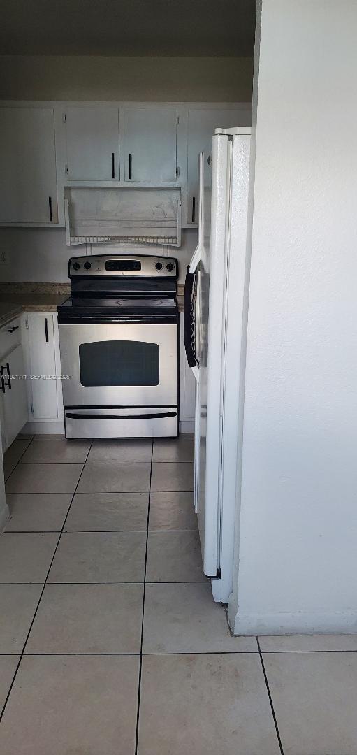 5702 West 26th Avenue, Unit 5702 Hialeah, FL 33016 - Photo 3 of 10 a stove top oven sitting inside of a kitchen