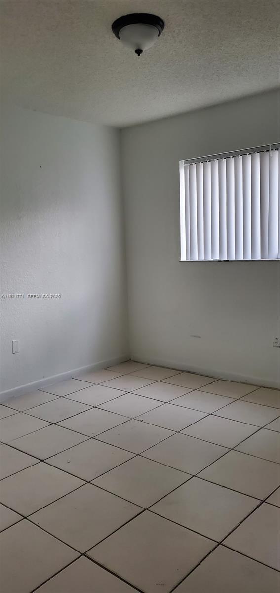 5702 West 26th Avenue, Unit 5702 Hialeah, FL 33016 - Photo 6 of 10 a view of an empty room and window