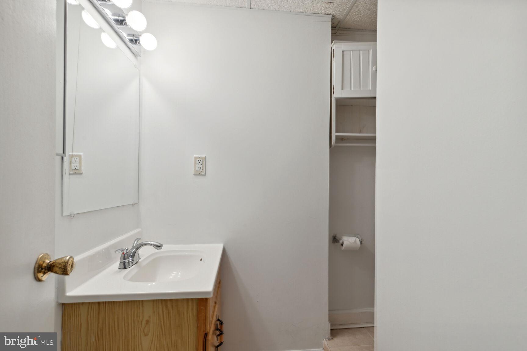 25636 Coltrane Drive Damascus, MD 20872 - Photo 15 of 26 a bathroom with a sink and a mirror