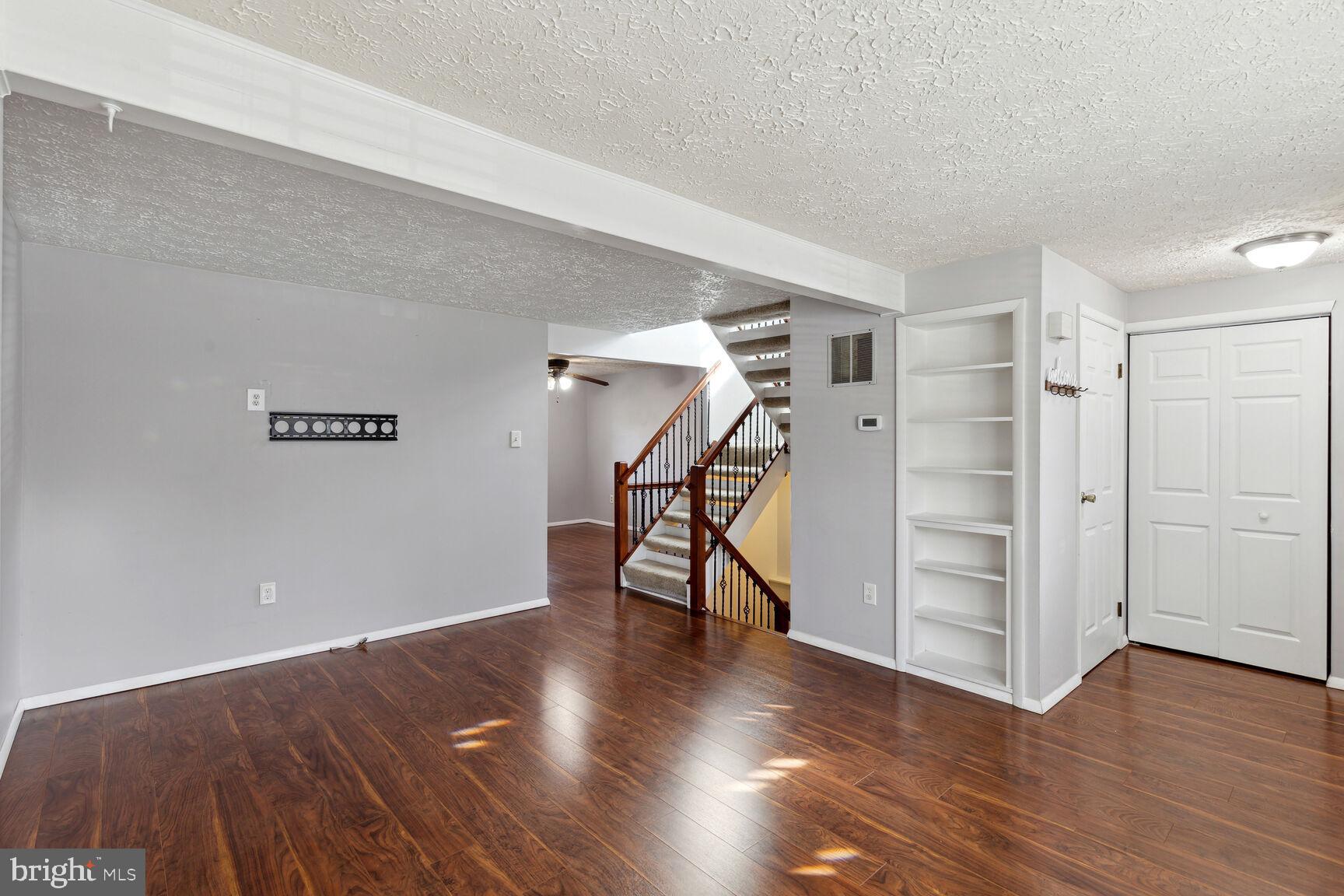 25636 Coltrane Drive Damascus, MD 20872 - Photo 18 of 26 a view of a room with wooden floor and stairs