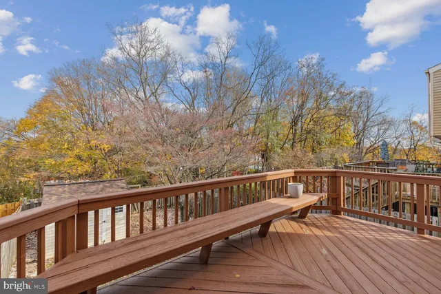 a view of balcony with wooden floor and fence