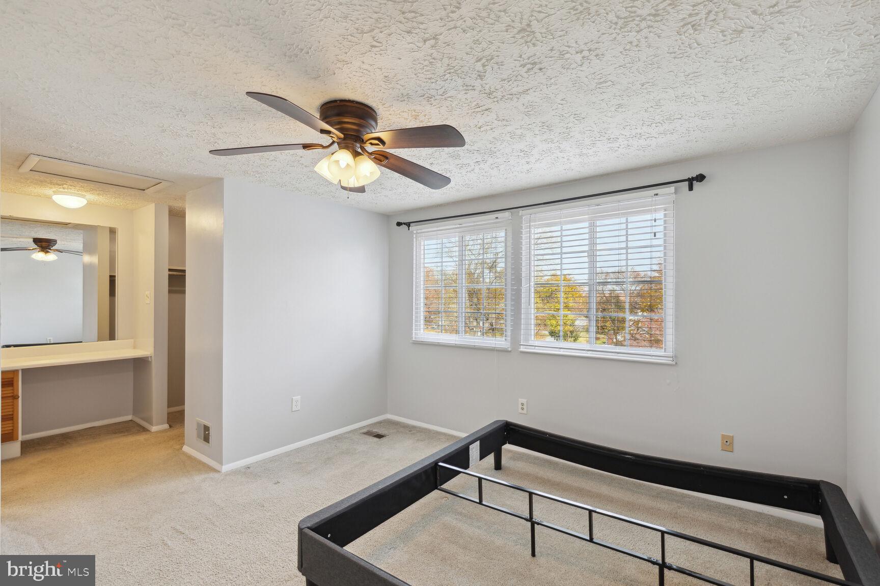 25636 Coltrane Drive Damascus, MD 20872 - Photo 5 of 26 a room with chandelier fan and windows