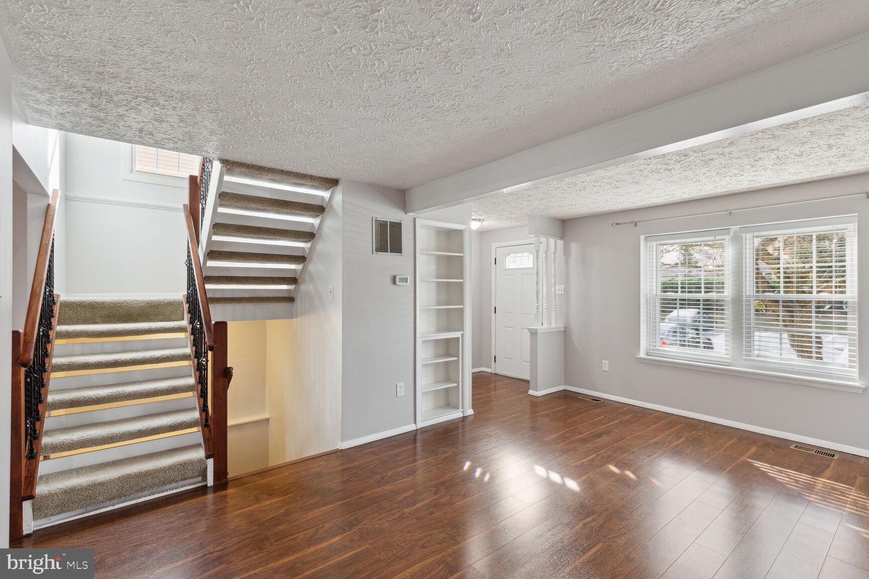 25636 Coltrane Drive Damascus, MD 20872 - Photo 6 of 26 an empty room with wooden floor and windows
