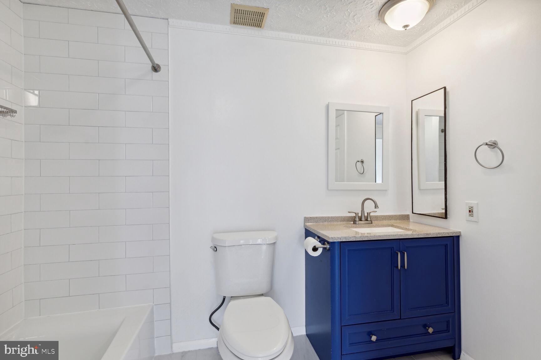 25636 Coltrane Drive Damascus, MD 20872 - Photo 9 of 26 a bathroom with a toilet a sink a vanity and mirror