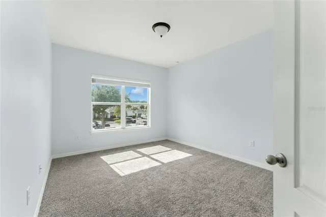 a view of an empty room and a window