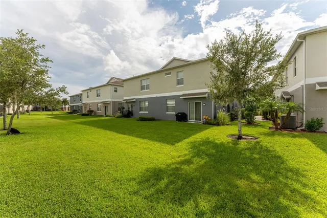 a front view of house with yard and green space