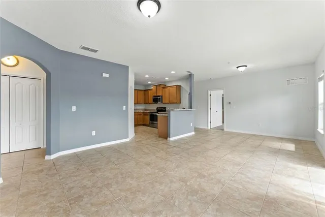 an empty room with cabinet and mirrors