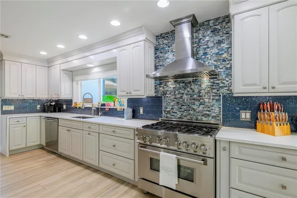 a kitchen with stainless steel appliances granite countertop a stove and cabinets