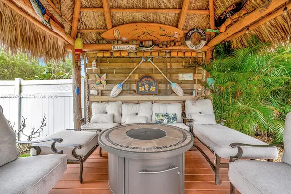 a front view of a house with garden and outdoor seating