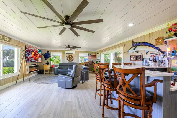 a view of a room with furniture and wooden floor