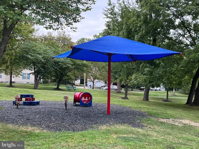 a view of outdoor space with playground and green space