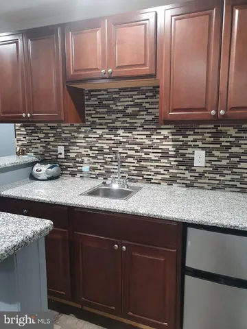 a kitchen with stainless steel appliances granite countertop wooden cabinets a sink and dishwasher