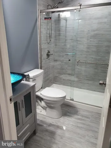 a bathroom with a toilet and a shower