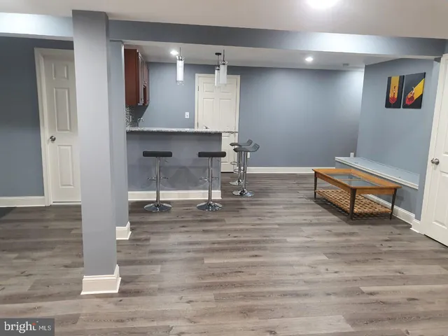 a room with wooden floor and furniture