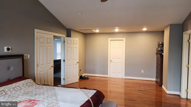 a view of a livingroom with wooden floor and kitchen