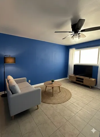 a living room with furniture and a flat screen tv