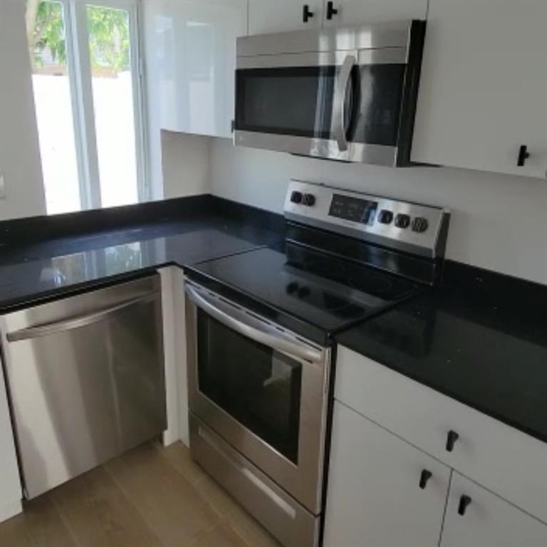 1744 Southwest 10th Street, Unit 3 Miami, FL 33135 - Photo 2 of 4 a kitchen with a stove microwave and sink