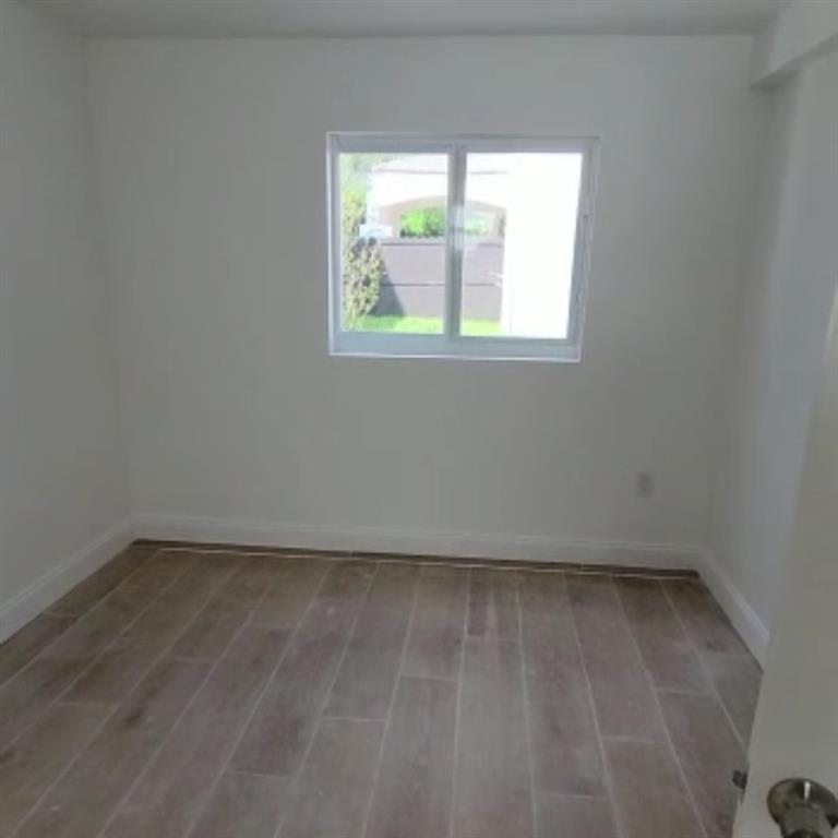 1744 Southwest 10th Street, Unit 3 Miami, FL 33135 - Photo 4 of 4 an empty room with a window