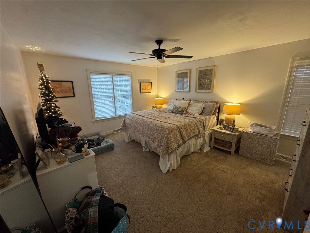 211 Pine Ridge Road Aylett, VA 23009 - Photo 11 of 11 a bedroom with a bed and a chandelier