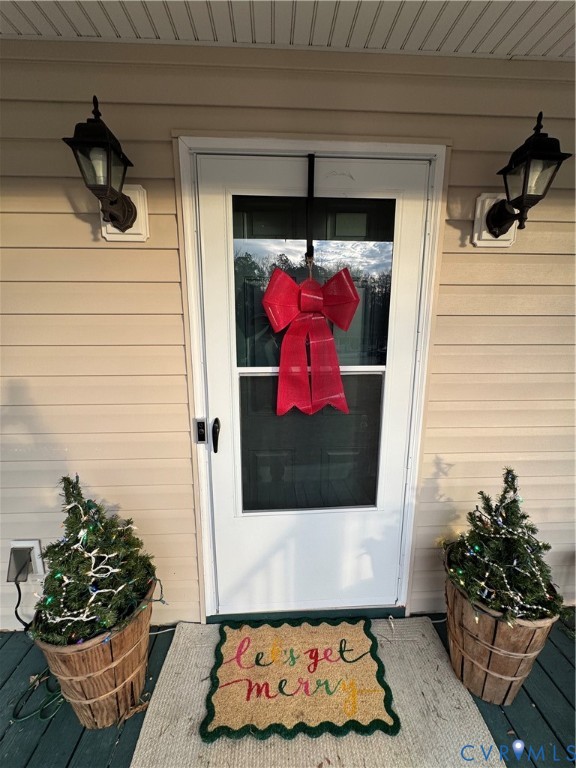 211 Pine Ridge Road Aylett, VA 23009 - Photo 2 of 11 a view of a door of the house with a potted plant