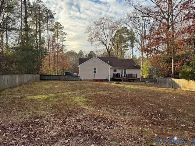 a view of a house with backyard and tree