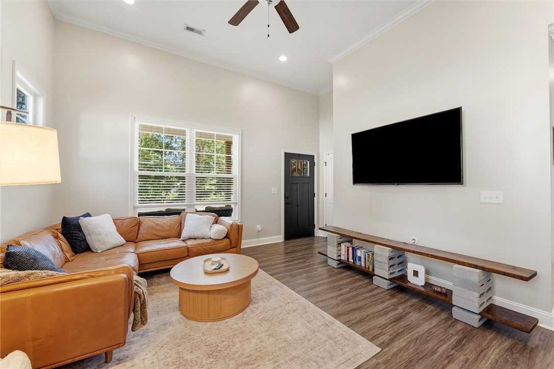 47 A Main Street Pelzer, SC 29669 - Photo 3 of 27 This airy living area features natural light, high ceilings, and beautiful flooring.