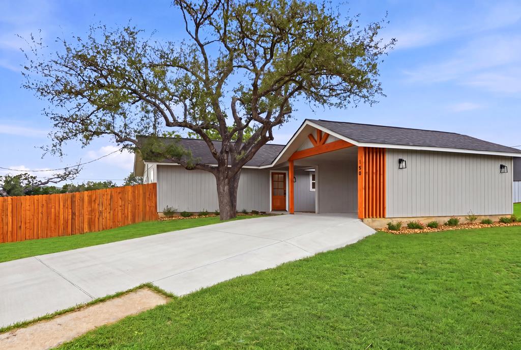 150 Oak Ridge Dr Center Point Center Point, TX 78010 - Photo 1 of 13 a front view of a house with a yard and garage