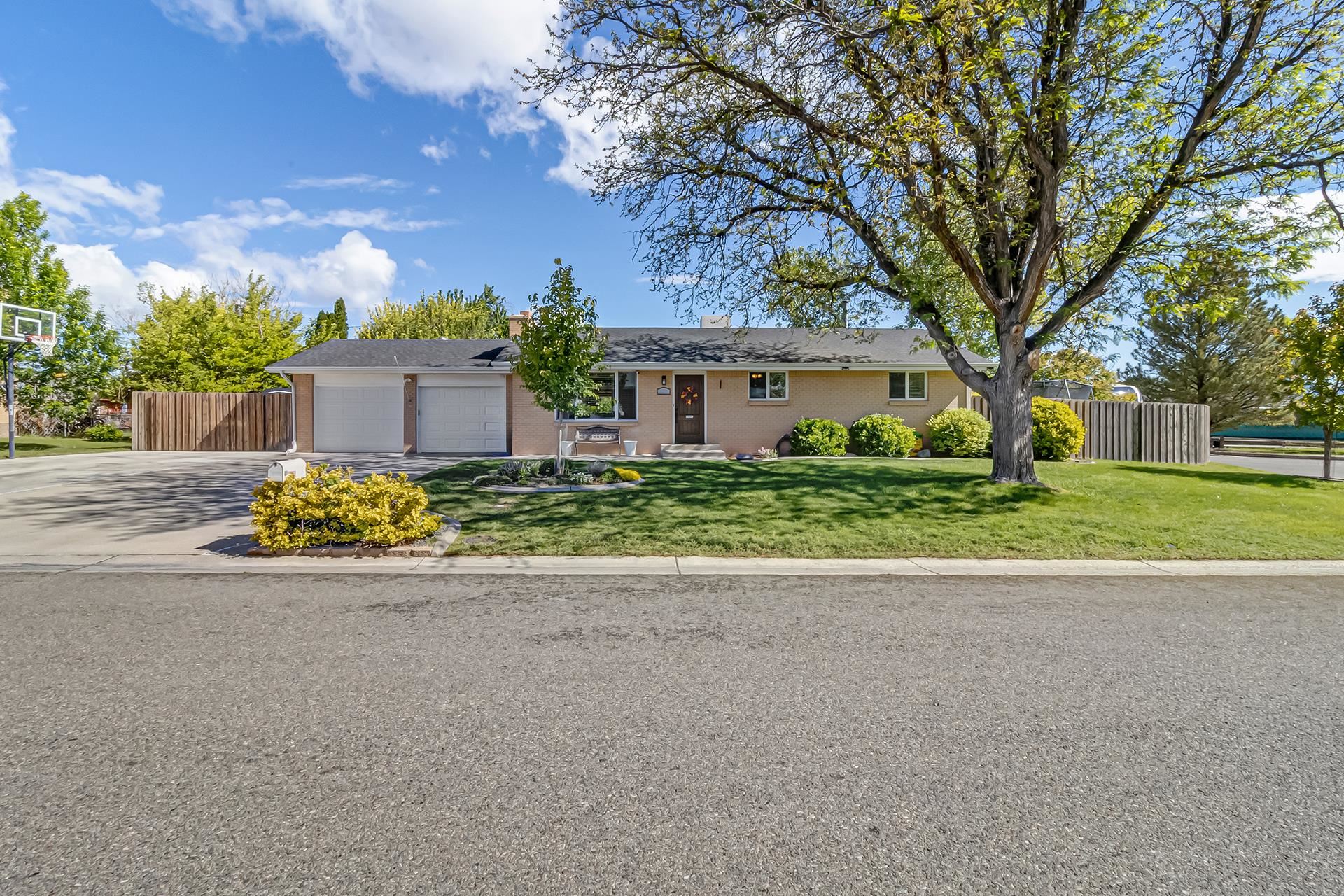 2118 Saguaro Road Grand Junction, CO 81507 - Photo 1 of 42 a front view of a house with a garden and trees