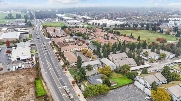 an aerial view of residential houses with outdoor space