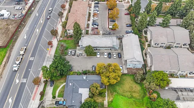 aerial view of a residential apartment building with a yard and potted plants