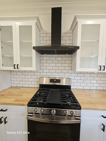 a stove top oven sitting inside of a kitchen