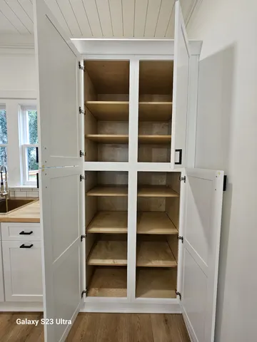 a view of walk in closet with empty racks