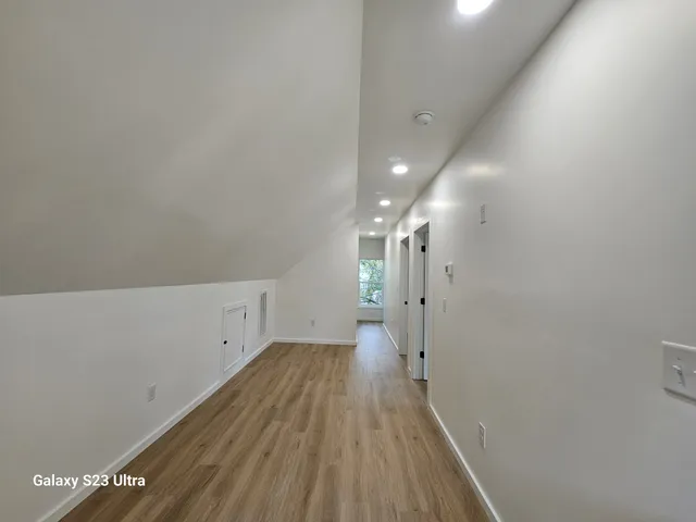 a view of a room with wooden floor