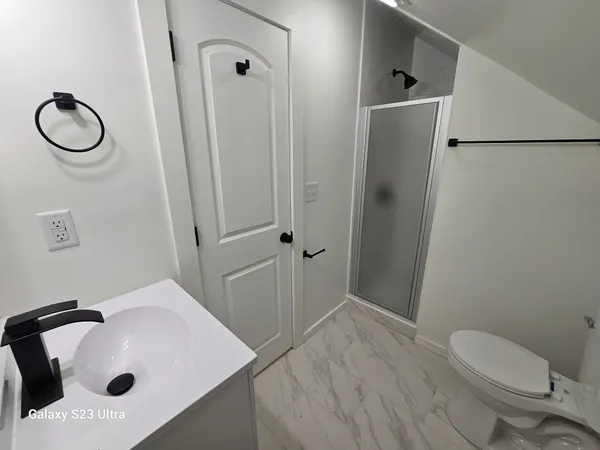a bathroom with a sink toilet and shower