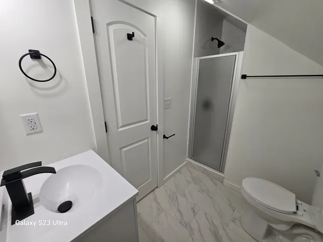 a bathroom with a sink toilet and shower