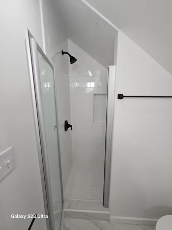 a bathroom with a glass door shower