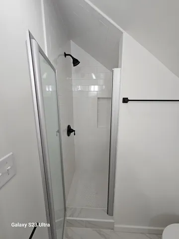 a bathroom with a glass door shower