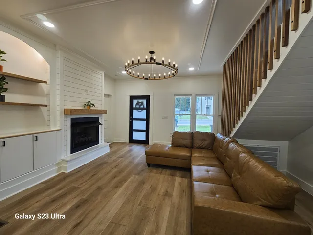 a living room with furniture and a fireplace